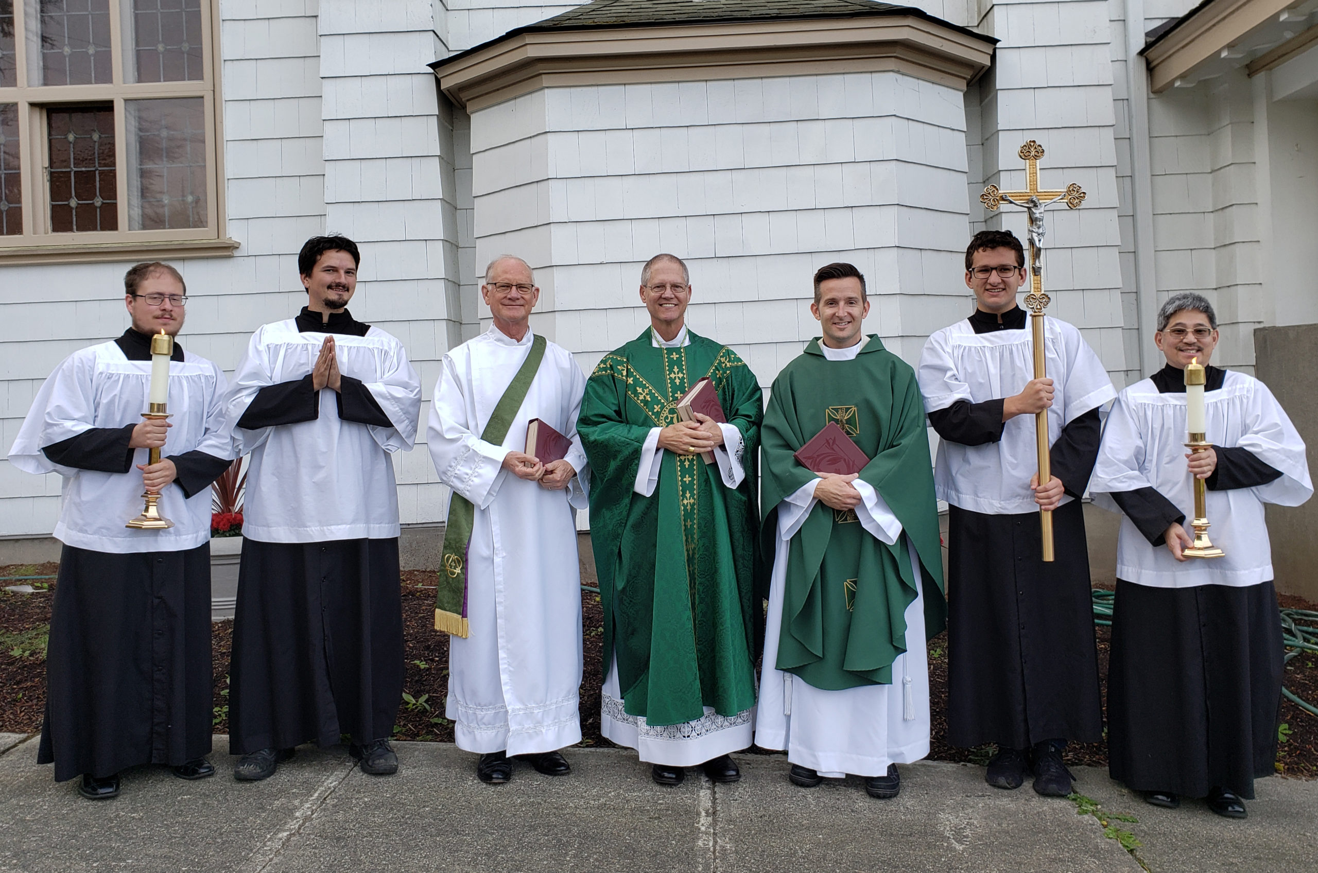 Archbishop Paul D. Etienne, Deacon Pierce Murphy, Rev. Cody Ross outside Sacred Heart, Bellingham, WA. Altar Servers, crucifix, green, books. September 19, 2019.