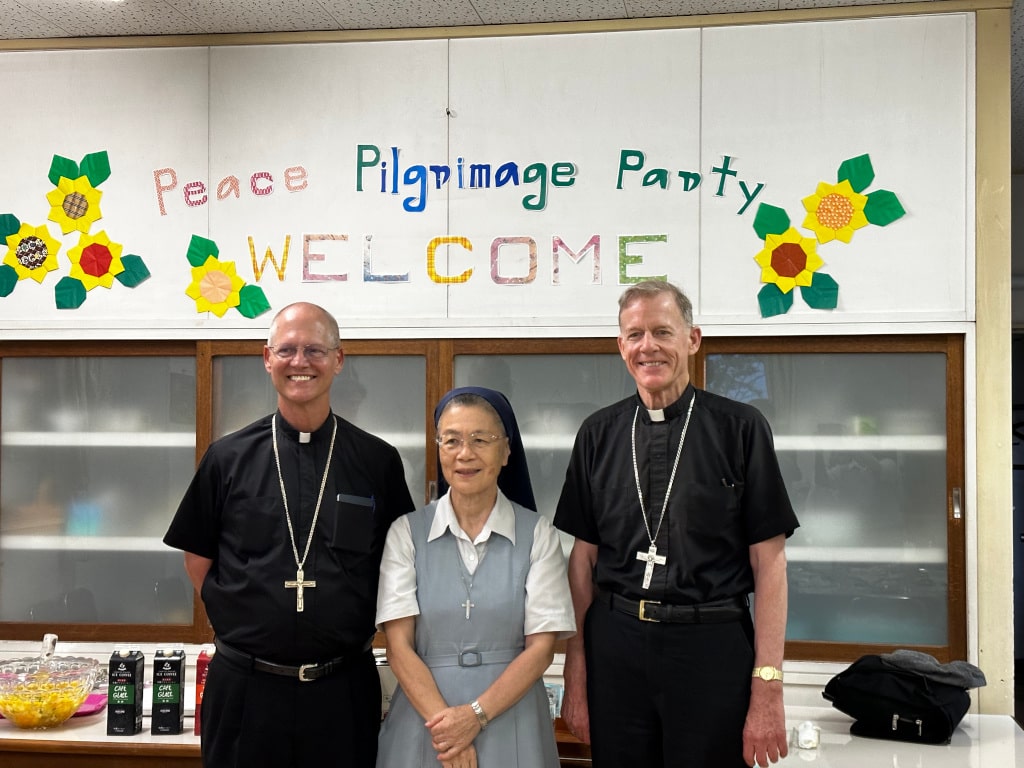 Archbishops with Mother Superior under their welcome sign