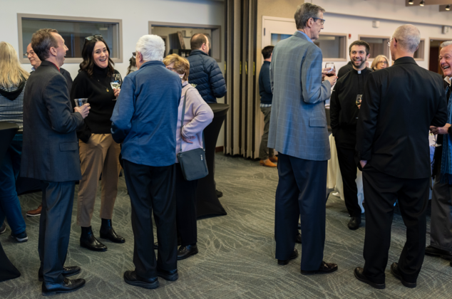 Father Ryan and others talking at the 2024 Crozier Lenten Retreat