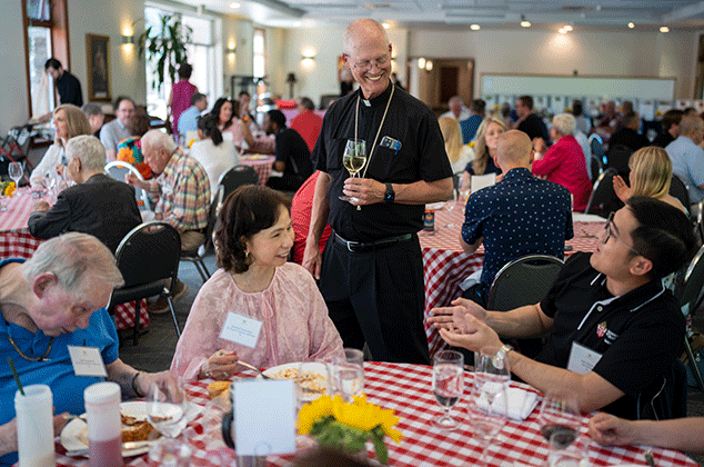Archbishop Etienne talking to people attending the 2025 BBQ