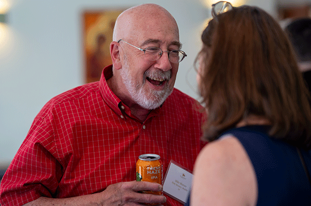 A man an woman talking and smiling at the 2025 BBQ