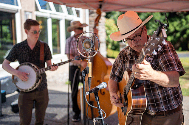 A band playing outside at the 2025 BBQ